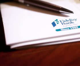 Photo of a Fidelity Bank Notebook and Pen on a table