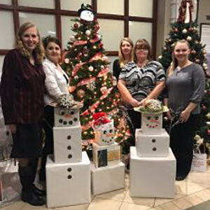 Christmas photo of team posed with boxy snowmen.