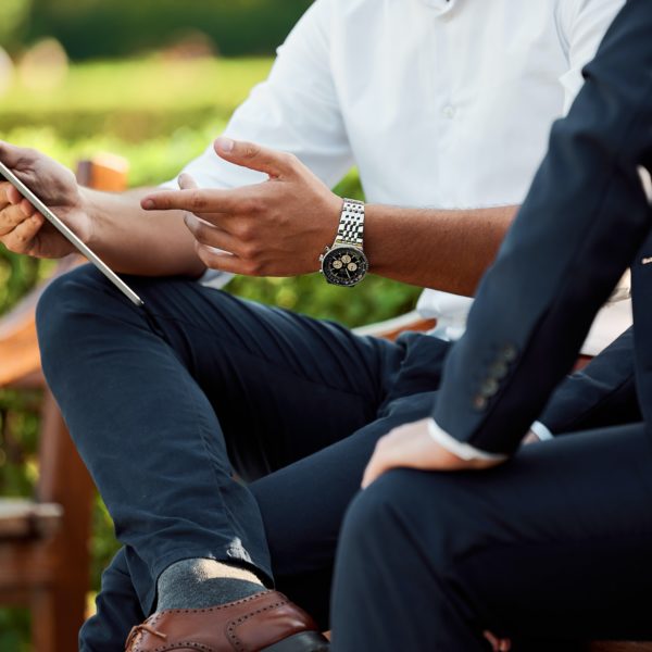 Hands indicating notes on a tablet