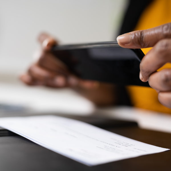 A woman taking a picture of a check