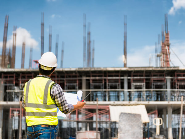 A construction worker looking at plans