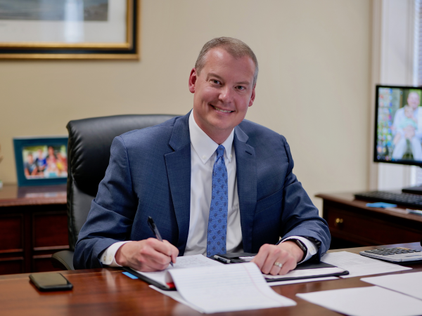 A man taking notes at a desk