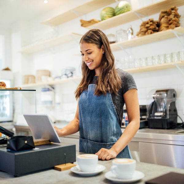 Female barista standing at cafe counter