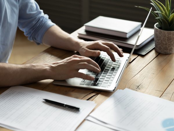 Close up businessman using laptop