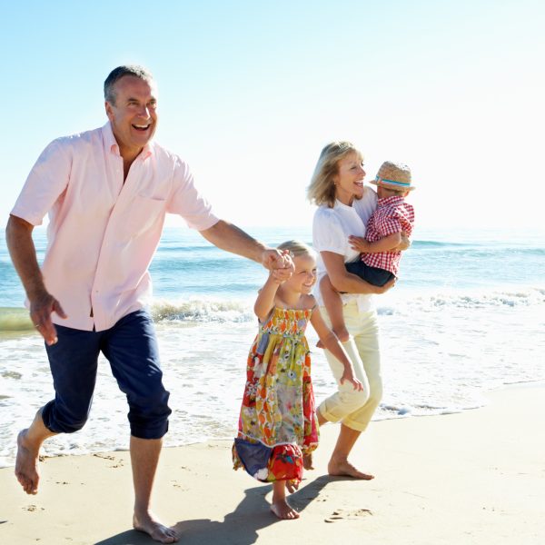 Grandparents and grandchildren enjoying the beach