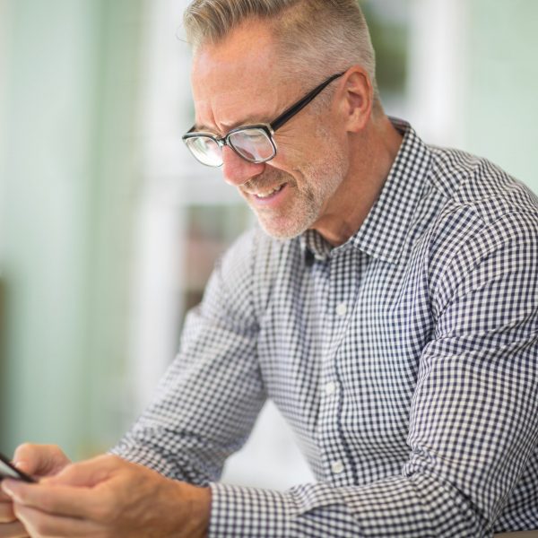 a man looking at his phone and smiling