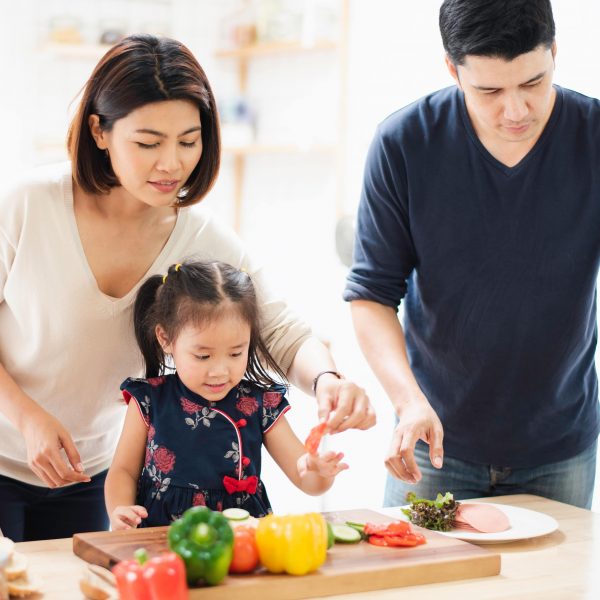 a young family preparing a meal in the kitchen