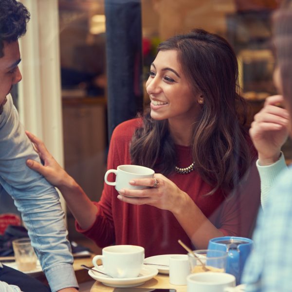 a small group of people chatting over coffee