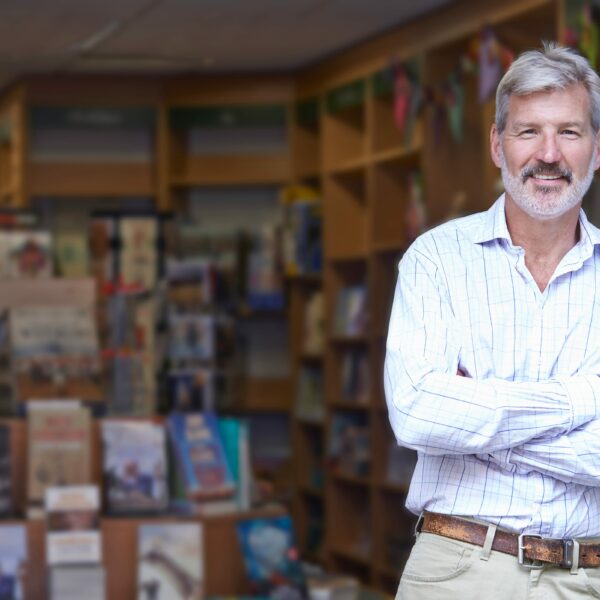 a man leaning in the entrance of a book shop