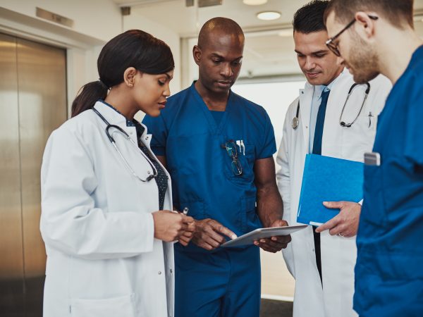 Multiracial team of doctors discussing a patient