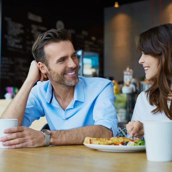 two people talking over a meal