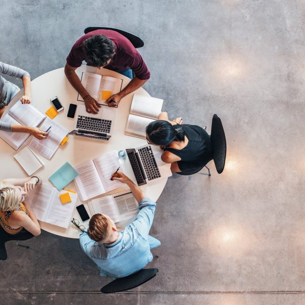 a group of people working at a round table