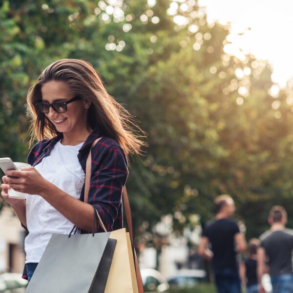 a woman looking at her phone while walking