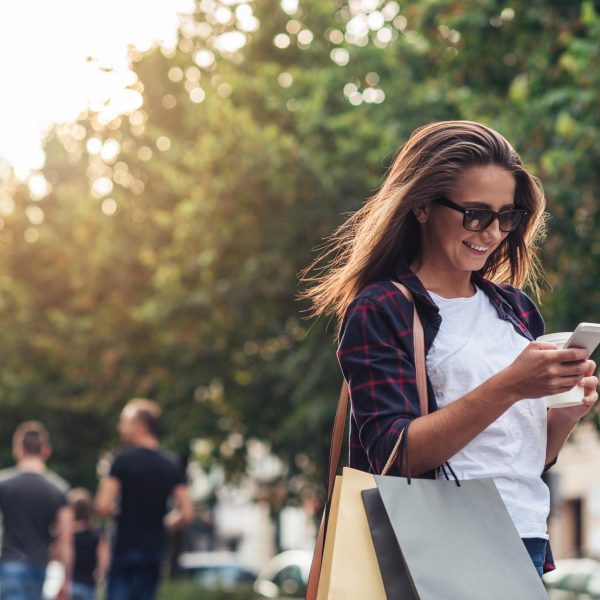 a woman looking at her phone while walking