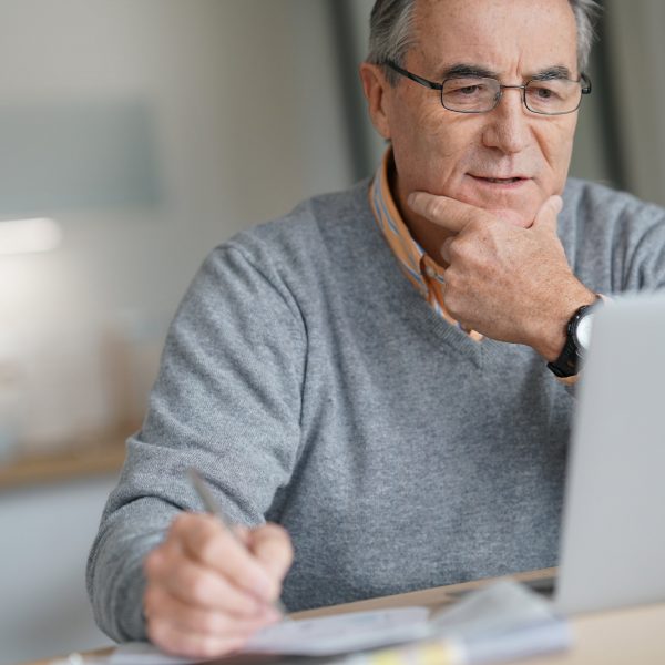 man looking at his laptop