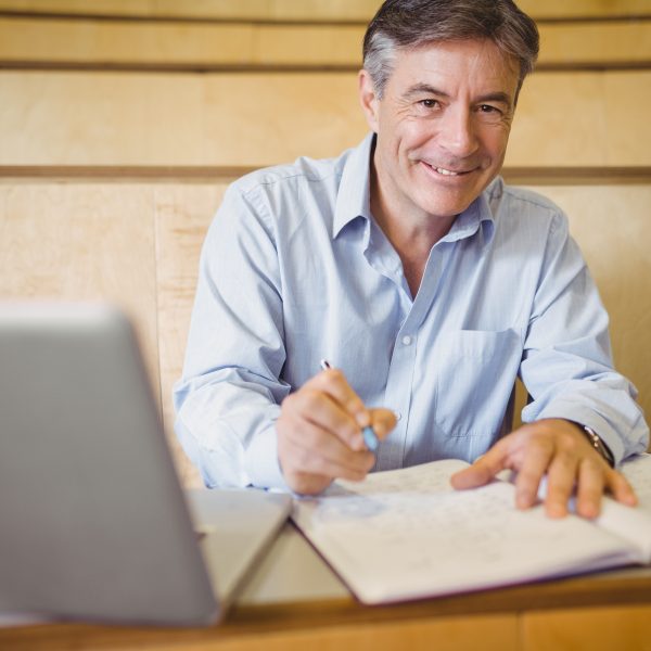 Man working in notebook with pencil