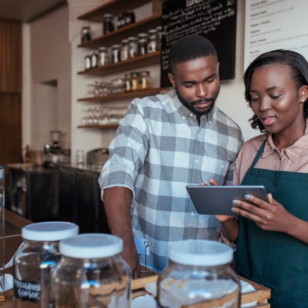 Women showing a customer something on a tablet