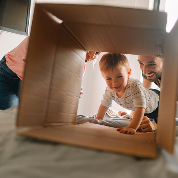 Young family with a little boy, being happy and excited about moving into a new home