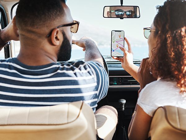 Couple in car looking at cell phone