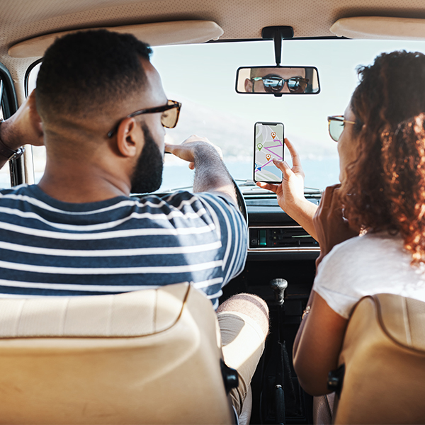 Couple in car looking at cell phone