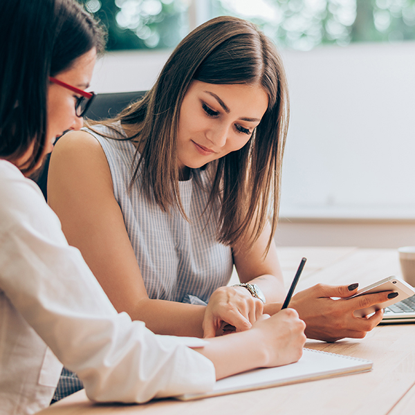 Two female colleagues in office working together