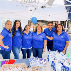 Associates in front of event table with goody bags