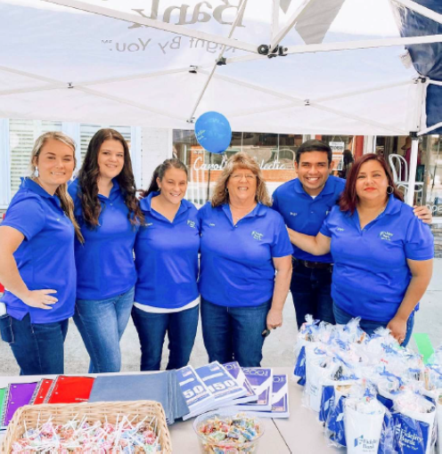 Associates in front of event table with goody bags