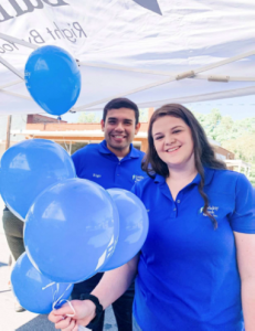 2 associates smiling with balloons