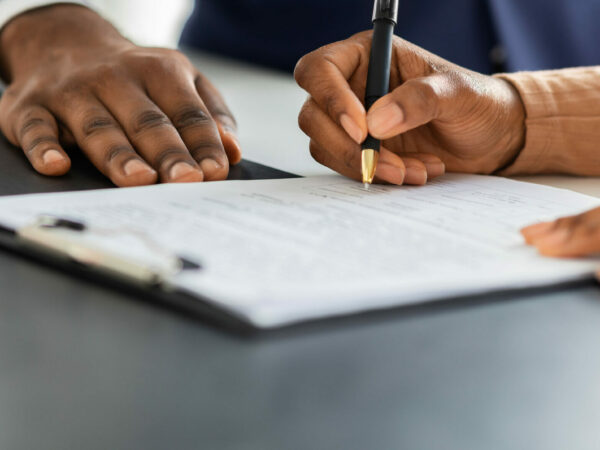 woman signing paper