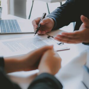 Three individuals in Business Meeting Reviewing Paperwork