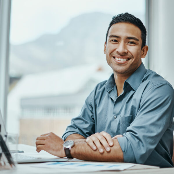 Shot of a young businessman using a laptop in a modern office