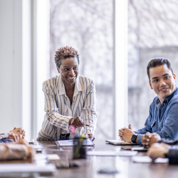 A small group of business professionals sit around a table