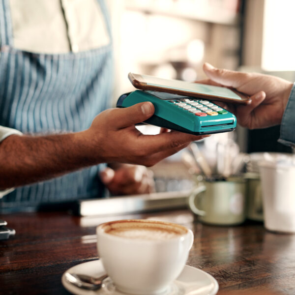 Person paying with phone at coffee shop