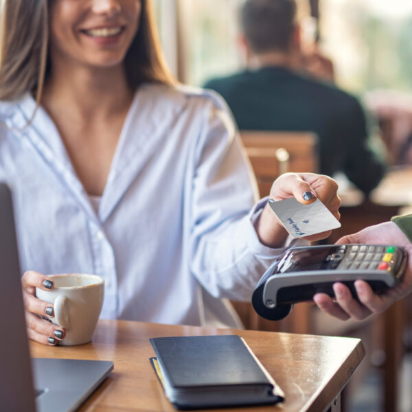 Woman Holding Coffee Cup Paying with Contactless Card