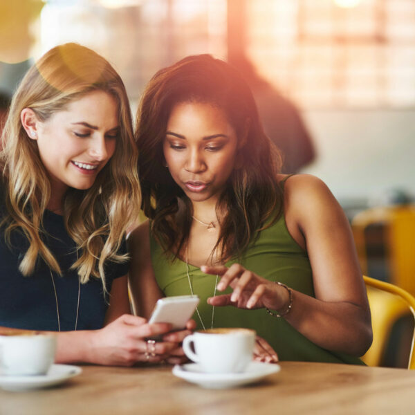 two women looking at a phone