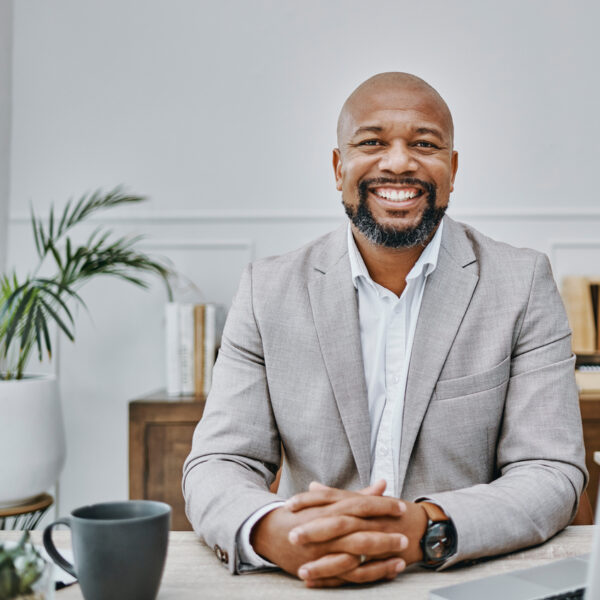 businessman smiling next to computer