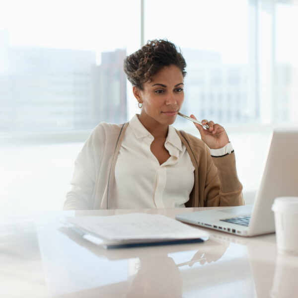 Businesswoman looking at laptop in office