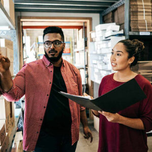 Business Owners in warehouse checking inventory