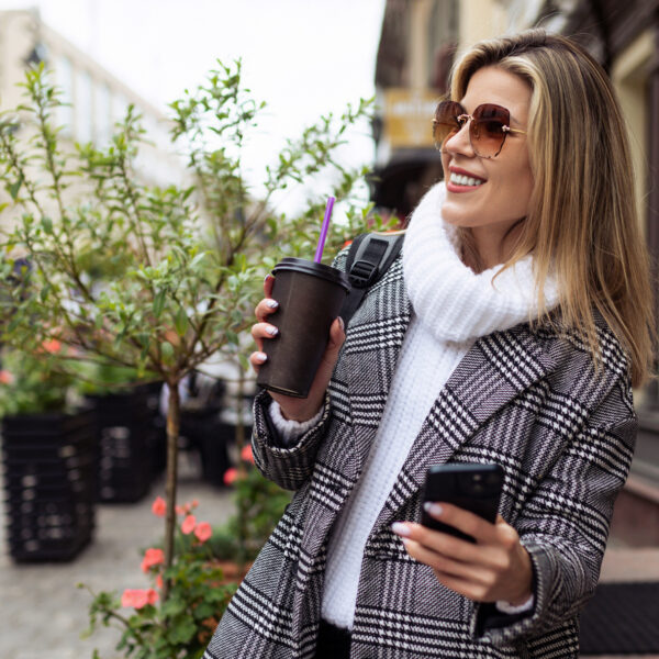 lady on phone holding coffee