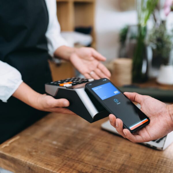 Close up of man paying with his phone