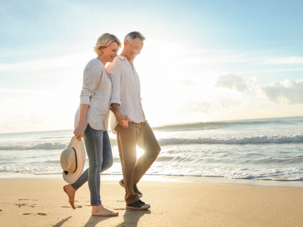 Couple walking on the beach holding hands